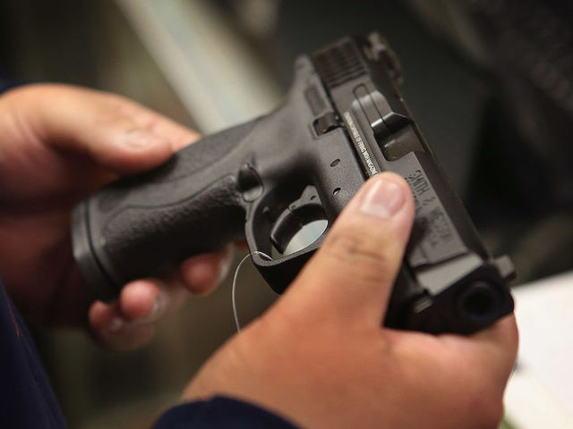 Gun-rights supporters hand out rifle magazines at a rally in Vermont